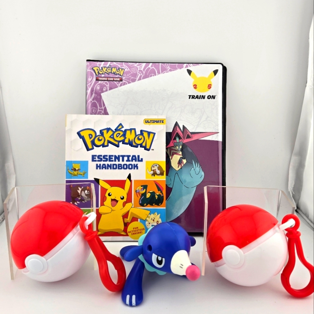 Pokemom Bundle. 2 empty Pokeball, 1 figure, 1 trading card album, 1 book.
